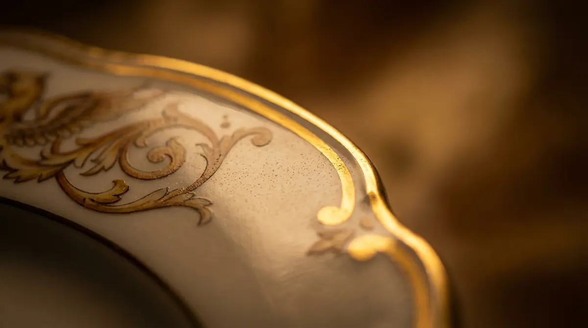 Макросъемка элитного костяного фарфора с нанесением 24-каратного золота, текстура оригинальной итальянской посуды, детали ручной работы и проверка качества глазури.